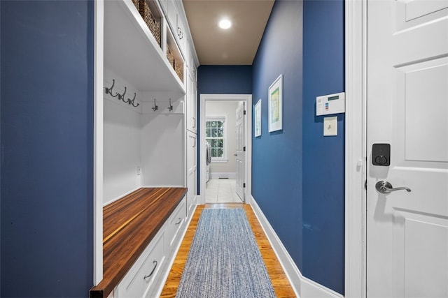 mudroom with baseboards and light wood-style floors