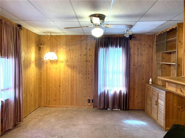 406 Peach St, City Of But Ne, PA 16001 - spare room featuring a drop ceiling, light colored carpet, wood walls, and ceiling fan