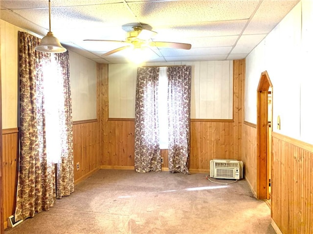 406 Peach St, City Of But Ne, PA 16001 - spare room featuring wooden walls, ceiling fan, wainscoting, carpet, and a drop ceiling