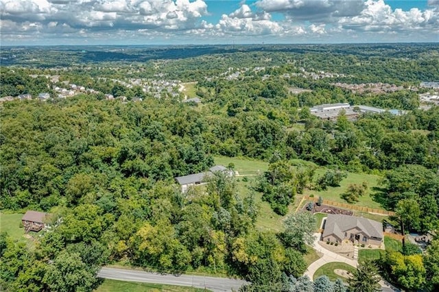 drone / aerial view featuring a wooded view