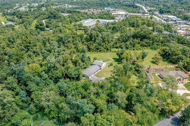 birds eye view of property with a view of trees