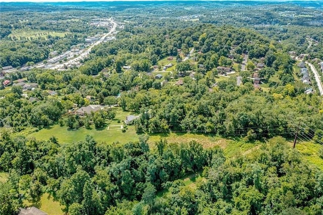 birds eye view of property featuring a wooded view