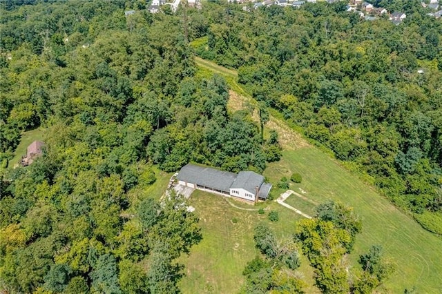 drone / aerial view with a wooded view