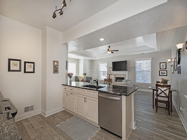 232 Adams Pointe Blvd Unit 6, Adams Twp, PA 16046 - kitchen featuring stainless steel dishwasher, a sink, a tray ceiling, a peninsula, and dark wood-style floors