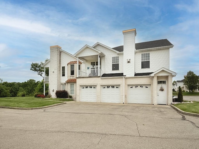 232 Adams Pointe Blvd Unit 6, Adams Twp, PA 16046 - view of front of home featuring a chimney, a garage, driveway, and a front lawn