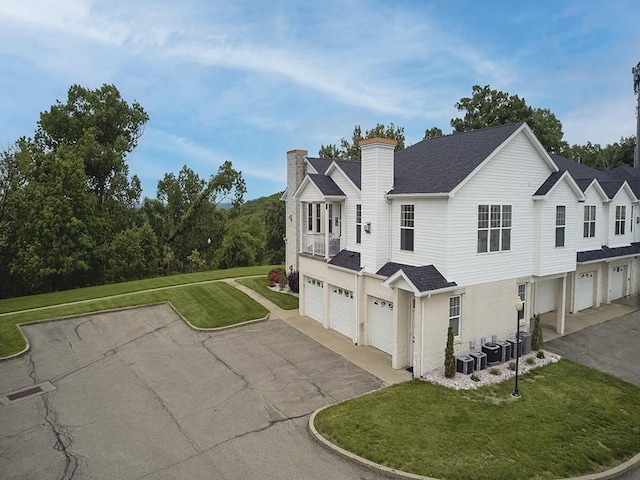 232 Adams Pointe Blvd Unit 6, Adams Twp, PA 16046 - view of property with an attached garage, driveway, a chimney, a front yard, and roof with shingles