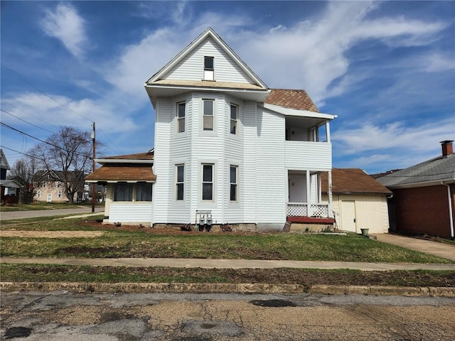 201 2nd St, City Of But Ne, PA 16001 - view of front of house with a balcony, roof with shingles, and a front lawn