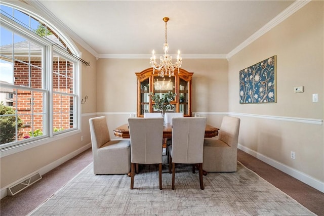 dining room featuring a chandelier, visible vents, carpet flooring, and baseboards