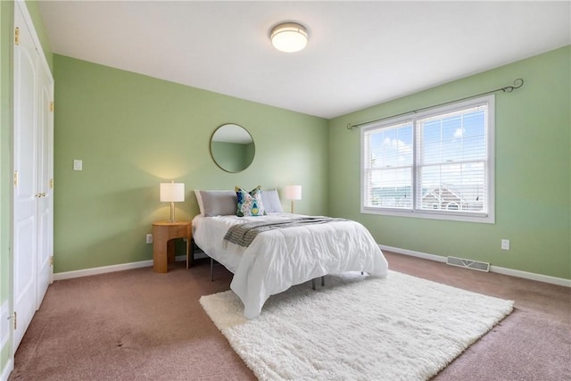 carpeted bedroom featuring visible vents and baseboards