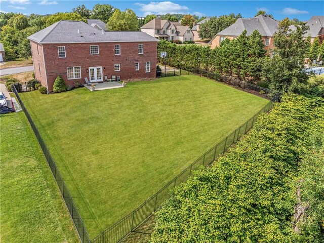 view of yard with french doors, a patio, and fence