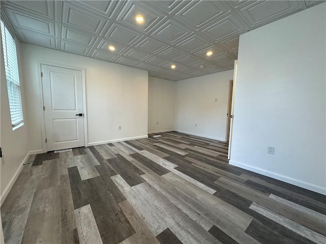 spare room featuring baseboards, recessed lighting, and an ornate ceiling