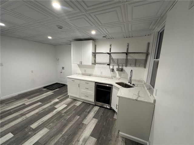 kitchen featuring white cabinets, light stone countertops, a sink, an ornate ceiling, and recessed lighting