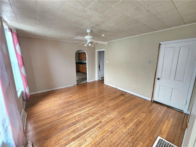 26 W Terrace Ave, New Castle/8Th, PA 16102 - empty room with baseboards, arched walkways, light wood-style floors, and ceiling fan