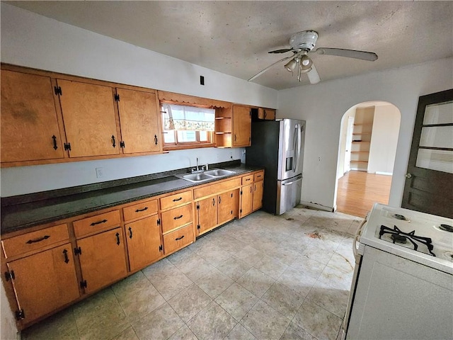 26 W Terrace Ave, New Castle/8Th, PA 16102 - kitchen with gas range gas stove, stainless steel fridge with ice dispenser, arched walkways, a ceiling fan, and a sink