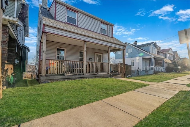 view of front of property featuring covered porch, a front lawn, and a residential view