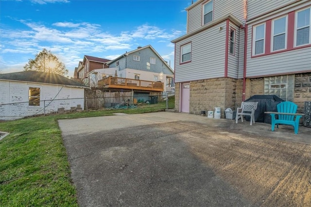 view of patio with fence and a garage