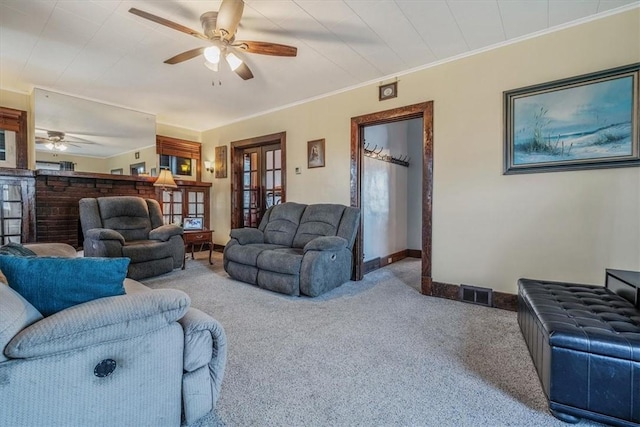 carpeted living area featuring a ceiling fan, french doors, baseboards, and ornamental molding