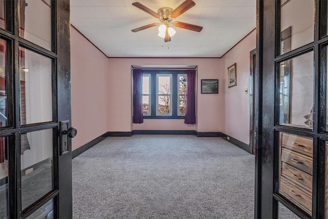 unfurnished room featuring carpet, baseboards, and ceiling fan
