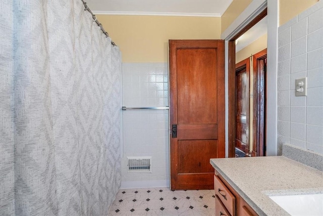 bathroom with tile walls, ornamental molding, vanity, and a shower with curtain