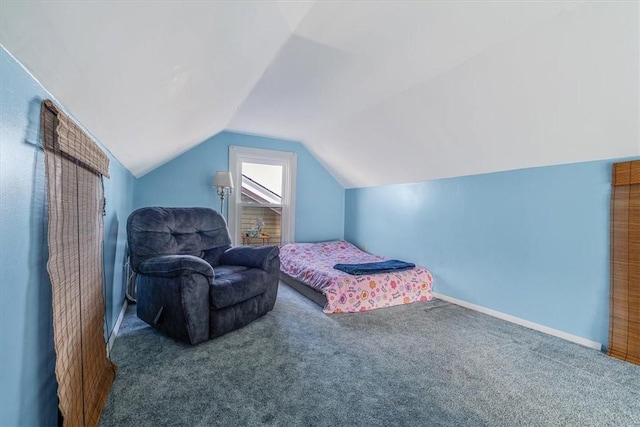 bedroom with carpet flooring and lofted ceiling