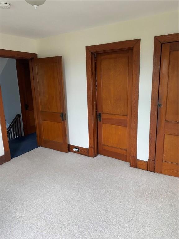unfurnished bedroom featuring carpet flooring and baseboards