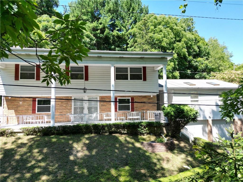 150 Hazel Kirk Rd, Carroll Twp, PA 15063 - view of front of home with covered porch and a front lawn