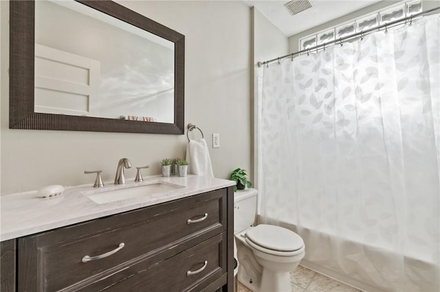 full bathroom featuring toilet, vanity, shower / bath combo with shower curtain, and tile patterned floors