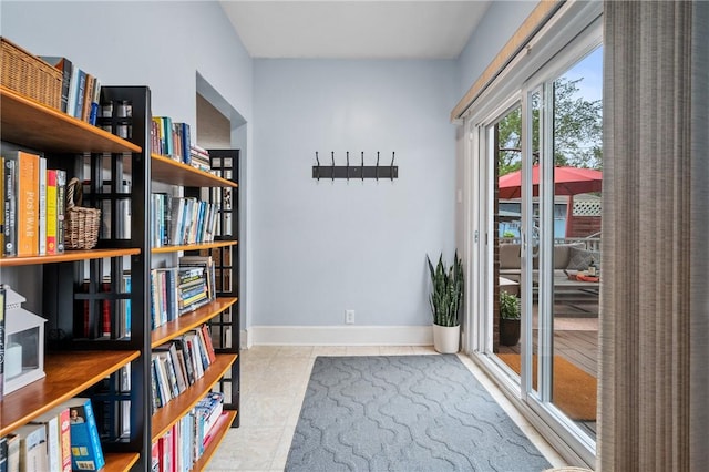 unfurnished room with baseboards