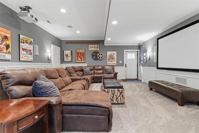 carpeted home theater room featuring recessed lighting, visible vents, wainscoting, and ornamental molding