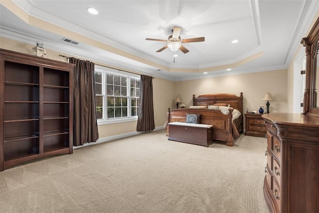 bedroom with visible vents, a tray ceiling, recessed lighting, crown molding, and light colored carpet