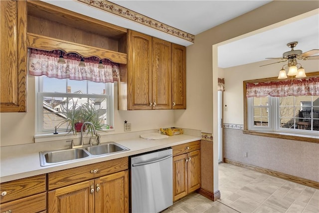 kitchen with a sink, a wainscoted wall, brown cabinets, and stainless steel dishwasher