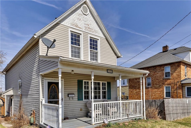 view of front of house with a porch and fence