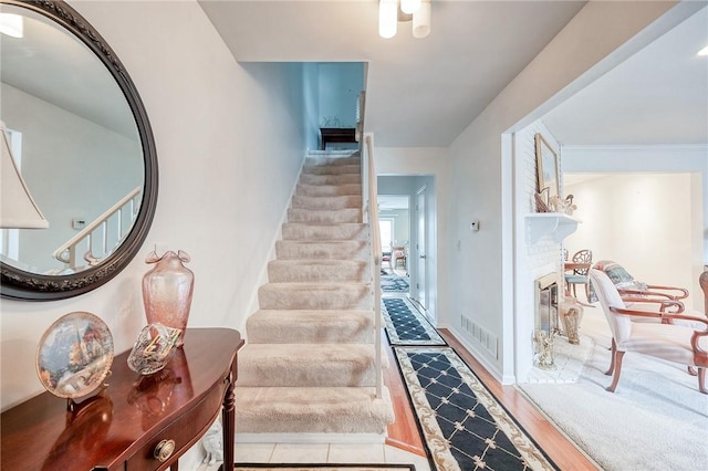 stairway with visible vents and wood finished floors