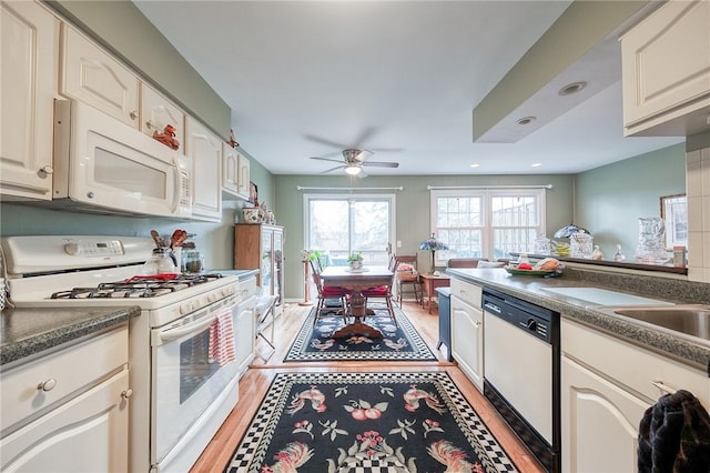 kitchen featuring dark countertops, ceiling fan, light wood-type flooring, recessed lighting, and white appliances