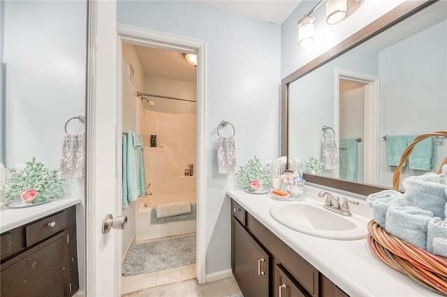bathroom featuring tile patterned flooring, tub / shower combination, and vanity