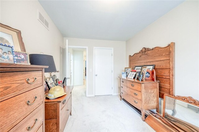 bedroom featuring light carpet and visible vents