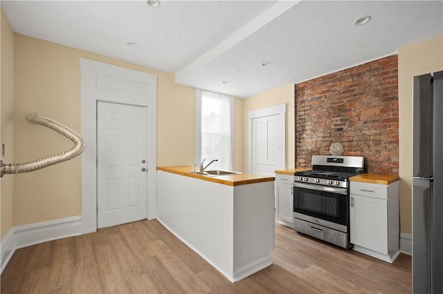 157-159 Grant Ave, Verona, PA 15147 - kitchen with a sink, butcher block counters, light wood finished floors, and stainless steel appliances