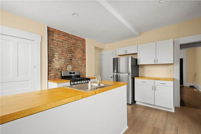 157-159 Grant Ave, Verona, PA 15147 - kitchen featuring butcher block countertops, appliances with stainless steel finishes, wood finished floors, and a sink