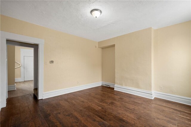 157-159 Grant Ave, Verona, PA 15147 - spare room featuring wood finished floors, baseboards, and a textured ceiling