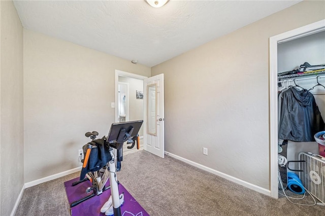 workout area with baseboards and carpet floors
