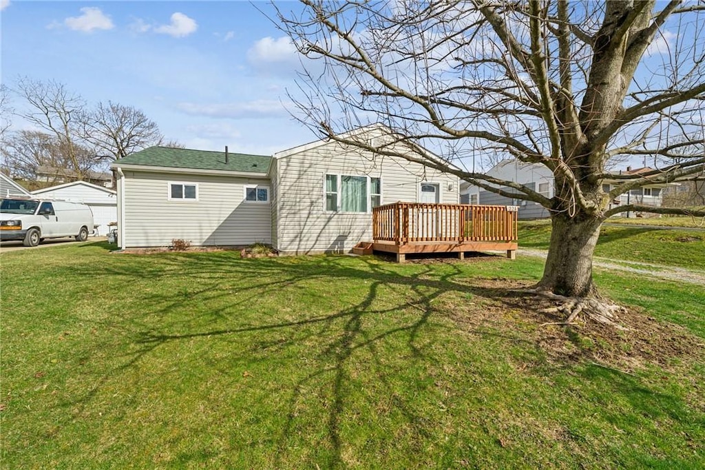 221 Porter Dr, Irwin, PA 15642 - rear view of property featuring a wooden deck and a lawn