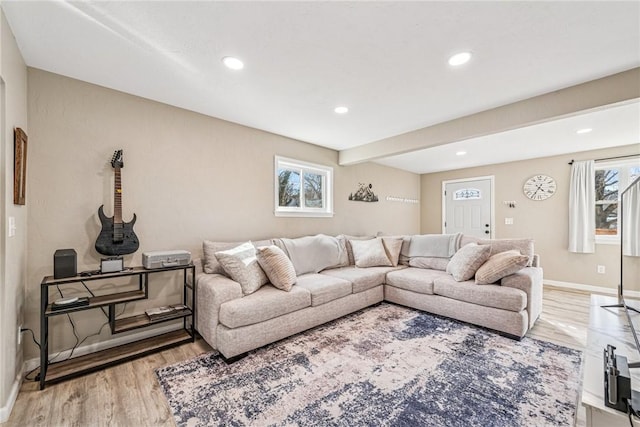 living area with recessed lighting, light wood-type flooring, and baseboards