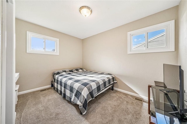 bedroom with carpet flooring, baseboards, and visible vents