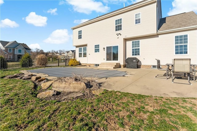 rear view of property featuring a fenced in pool, a patio, fence, and entry steps