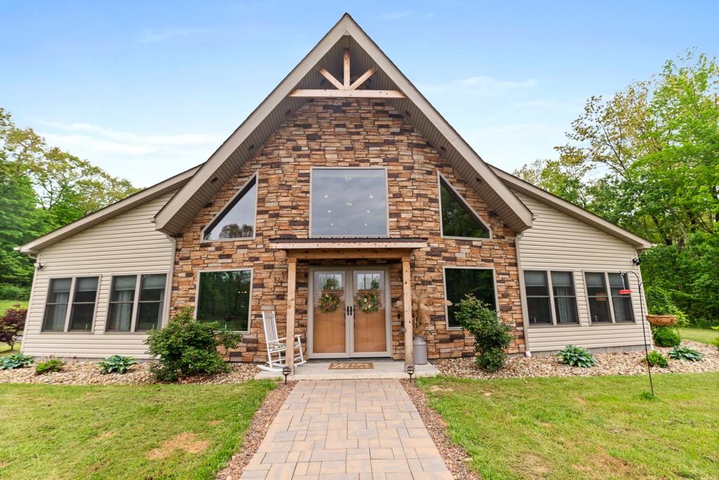 125 Ray Rd, Green Twp, PA 16134 - view of front of property with stone siding, french doors, and a front lawn
