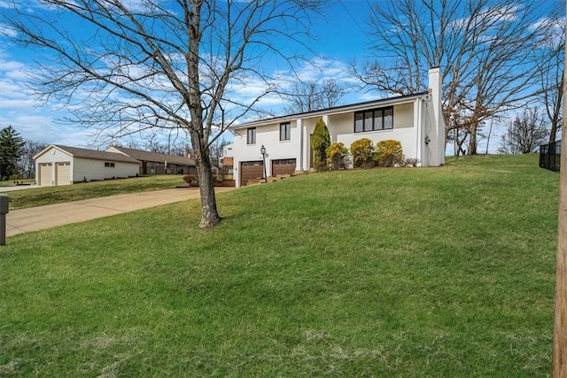 1693 Emery Dr, Mccandless, PA 15101 - view of front of house with concrete driveway, a chimney, stucco siding, a front lawn, and an attached garage