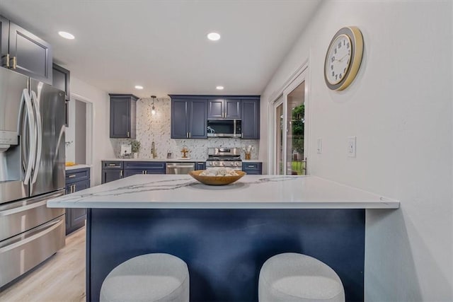 1693 Emery Dr, Mccandless, PA 15101 - kitchen with stainless steel appliances, a peninsula, a breakfast bar area, decorative backsplash, and recessed lighting