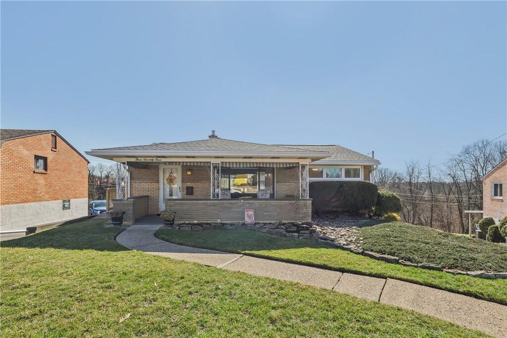373 Livingston, West Mifflin, PA 15122 - bungalow featuring brick siding and a front yard