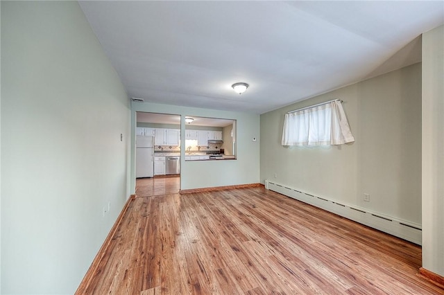248 Spruceton Ave, Mt Lebanon, PA 15228 - unfurnished living room with a baseboard heating unit, baseboards, visible vents, light wood finished floors, and a sink