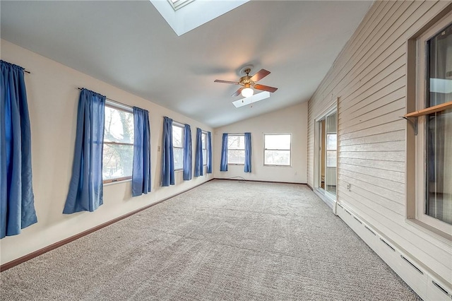 248 Spruceton Ave, Mt Lebanon, PA 15228 - carpeted empty room featuring vaulted ceiling with skylight, a healthy amount of sunlight, a baseboard heating unit, and ceiling fan